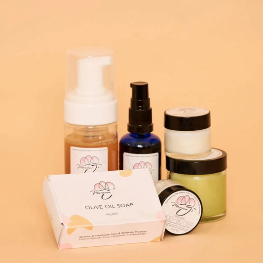 Natural skincare products from New Zealand arranged outdoors among lush greenery